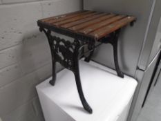 A cast iron wooden slatted patio occasional table.