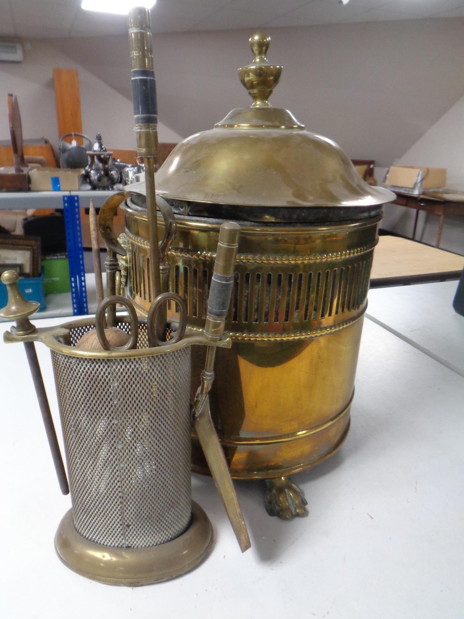 A 19th century brass lidded coal bucket with lion mask handles,