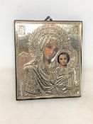 A religious icon with sterling silver overlay decoration, 12.5 cm x 14.5 cm.