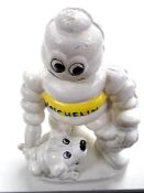 A cast iron figure, Michelin man with dog.