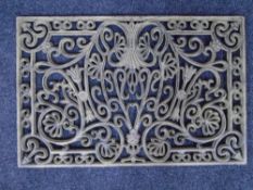 A cast iron rectangular doormat.