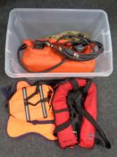 A box containing a marine fuel container and two inflatable lifejackets.