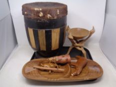 A tray containing African tourist items including hide upholstered hand drum, wooden serving dish,