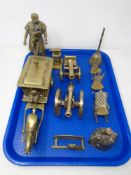 A tray containing assorted brass ornaments including horse and cart, blacksmith and anvil,
