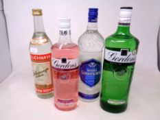 Four bottles of alcohol including Gordons Dry London Gin (1 Litre), Gordons Premium Pink Gin (0.