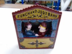 A cast iron Punch and Judy money box.