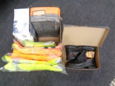 A box containing three pairs of work safety boots (boxed) together with high visibility clothing.