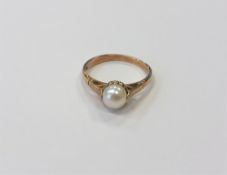 A 9ct yellow gold ring set with a pearl, 1.8g, size M.