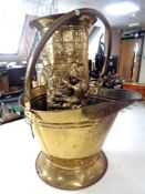 A brass coal bucket and a brass stick stand