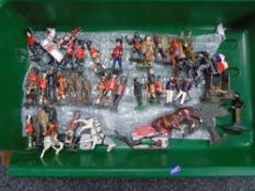 A tub containing a quantity of mid-20th century hand painted lead figures including soldiers,