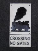 A cast iron wall plaque, train level crossing.