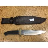 A bowie knife in leather sheath (lacks grip)