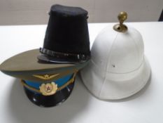 A Russian military cap, a further cap and a helmet.