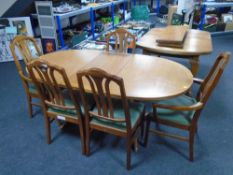 A Parker Knoll oval teak extending table together with five Nathan teak dining chairs