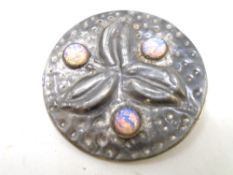 An Arts and Crafts opal and pewter brooch.