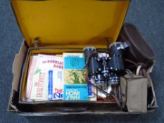 A box of vintage leather case containing maps, Kodak camera,