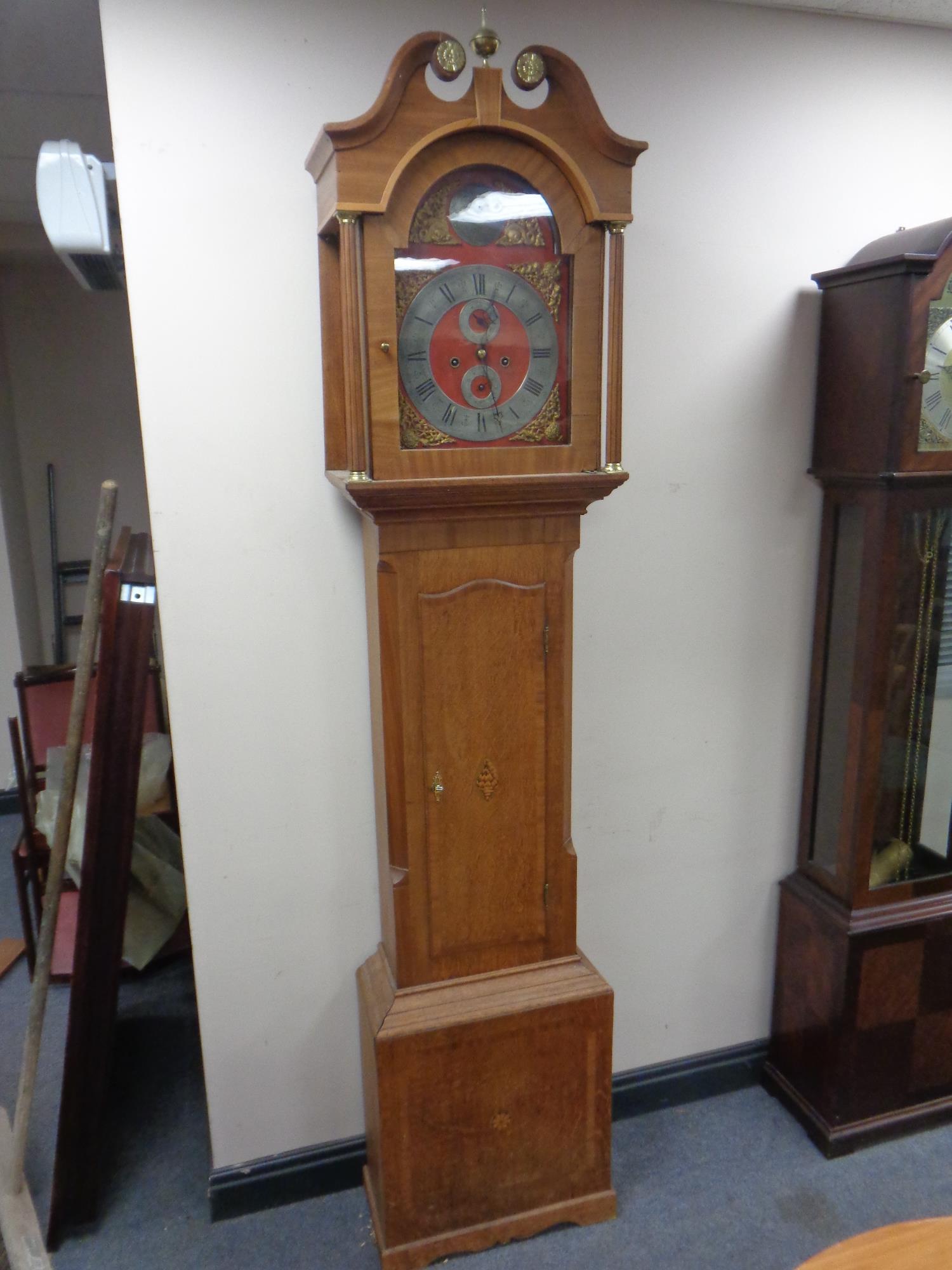 A continental oak longcase clock with brass and silver dial signed Christian Wiuvel with pendulum