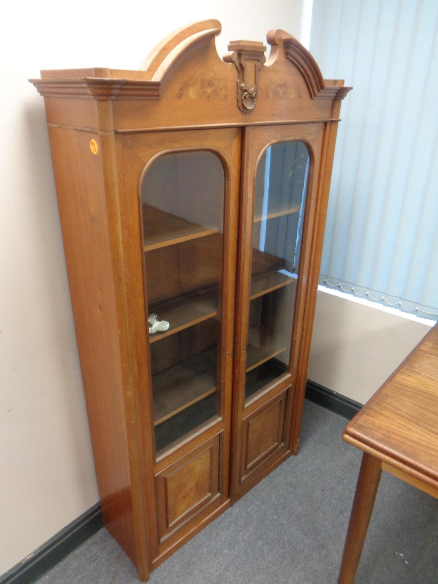 A 19th century continental oak and burr walnut glazed door bookcase