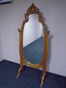 A reproduction carved beech cheval mirror.