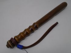 A wooden truncheon.