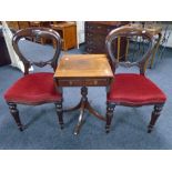 A pair of Victorian balloon backed chairs together with a mahogany pedestal occasional table