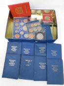 A tin containing assorted coinage including crowns, Britain's first decimal coin set,