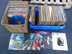 A box and a crate containing vinyl records including Phil Collins, The Beatles, Iron Maiden,