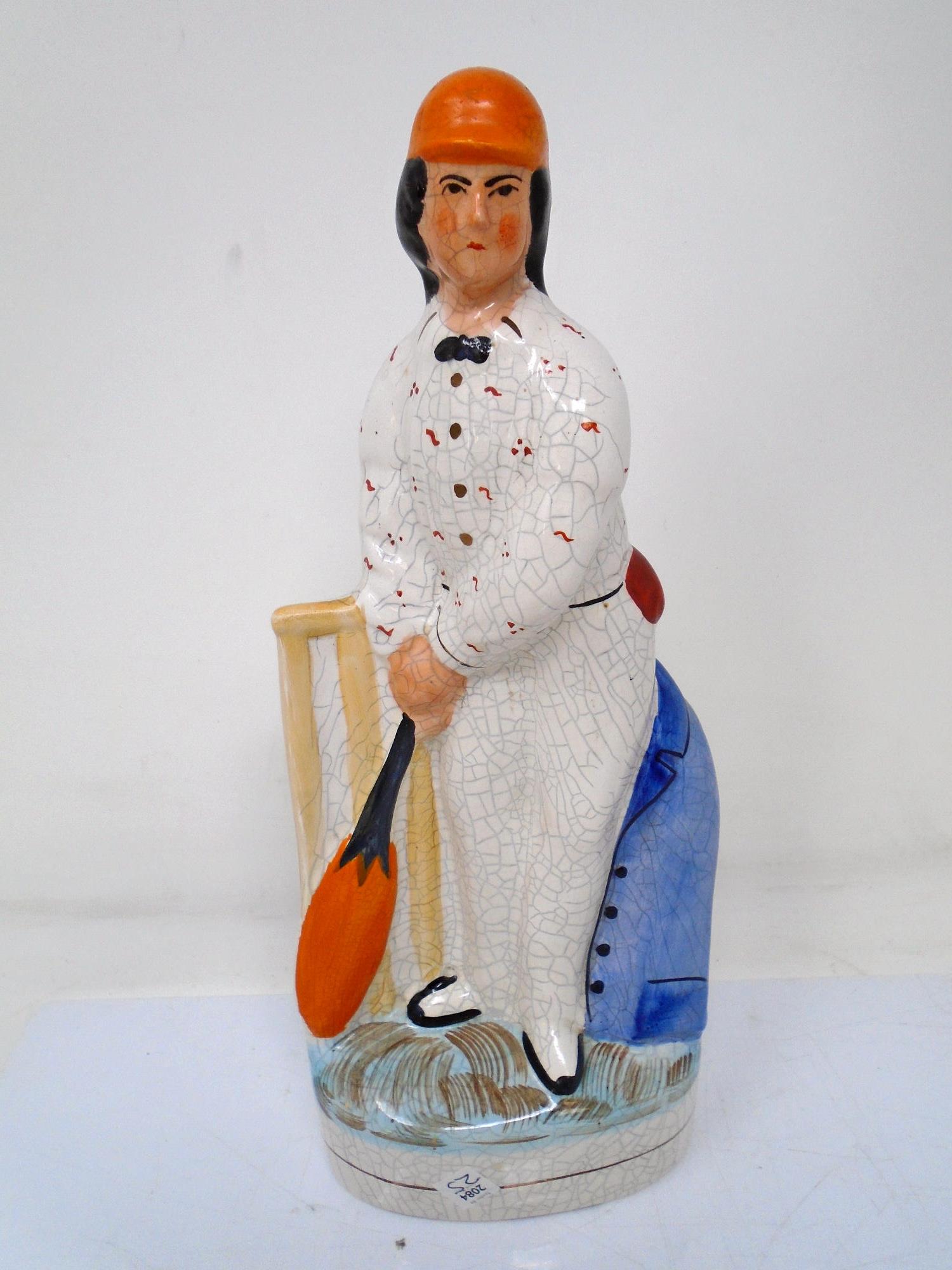 An antique Staffordshire flat backed figure The Cricketer.