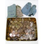 A tin containing a large quantity of pre-decimal British coinage including Queen Elizabeth pennies,