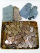 A tin containing a large quantity of pre-decimal British coinage including Queen Elizabeth pennies,