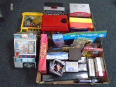 Two boxes containing six miniature vending, grab and arcade machines together with new novelty toys.