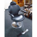 A hydraulic barber's armchair with footrest