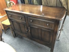 An Ercol elm and beech two door sideboard in antique finish