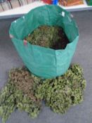 A bag containing a large quantity of camouflaged netting.
