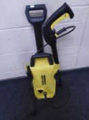 A Karcher pressure washer with hose and lance.