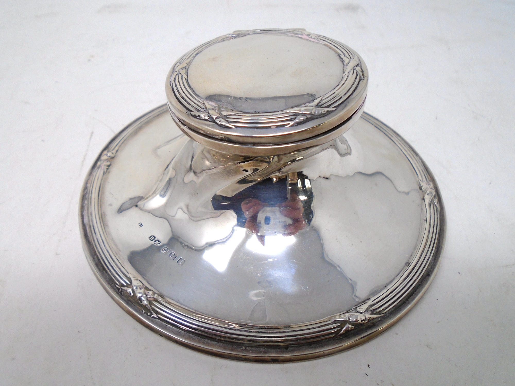 A Birmingham silver inkwell with Bakelite liner.