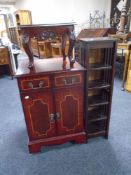 An inlaid audio cabinet together with a mahogany stool and a CD storage rack.
