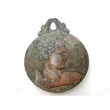 A bronze clip depicting a Greek figure.