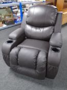 An electric reclining armchair with cup holders