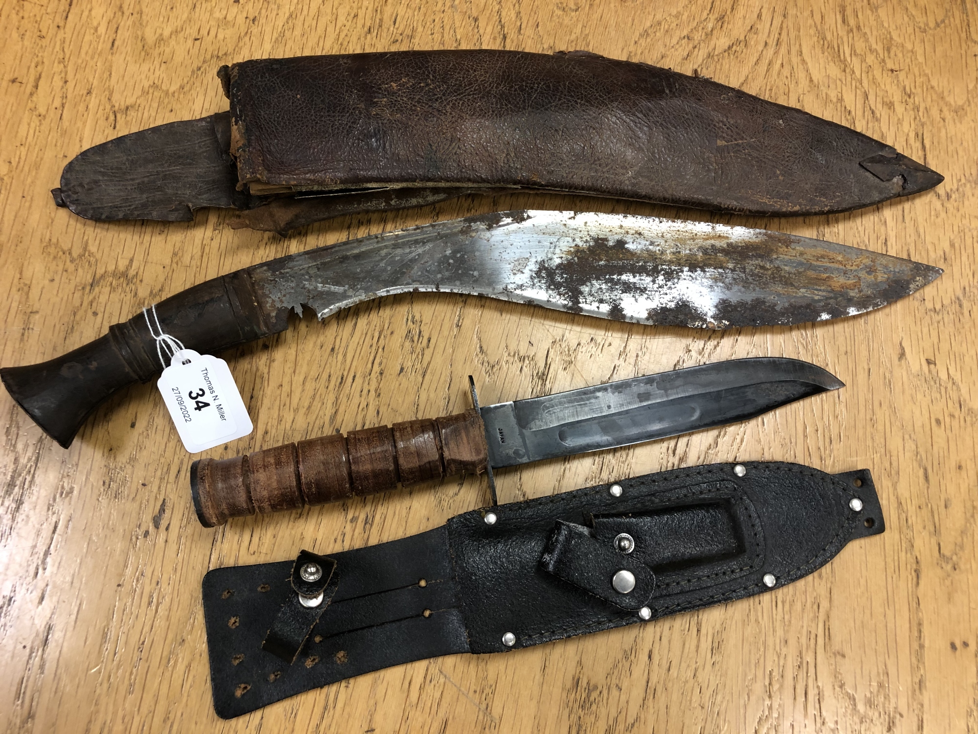 An antique Nepalese kukri in sheath (a/f) together with a further knife stamped Japan, in sheath.