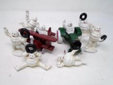 Eight cast iron figures, Michelin man in biplane,