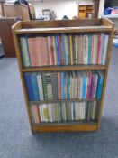 A set of oak sliding glass door shelves together with three shelves of books including religious,