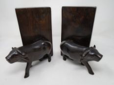 A pair of carved hardwood water buffalo bookends