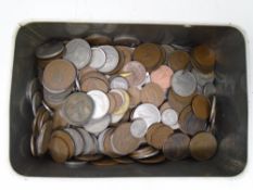 A tin containing Irish coins dating from the 17th to the 20th century.