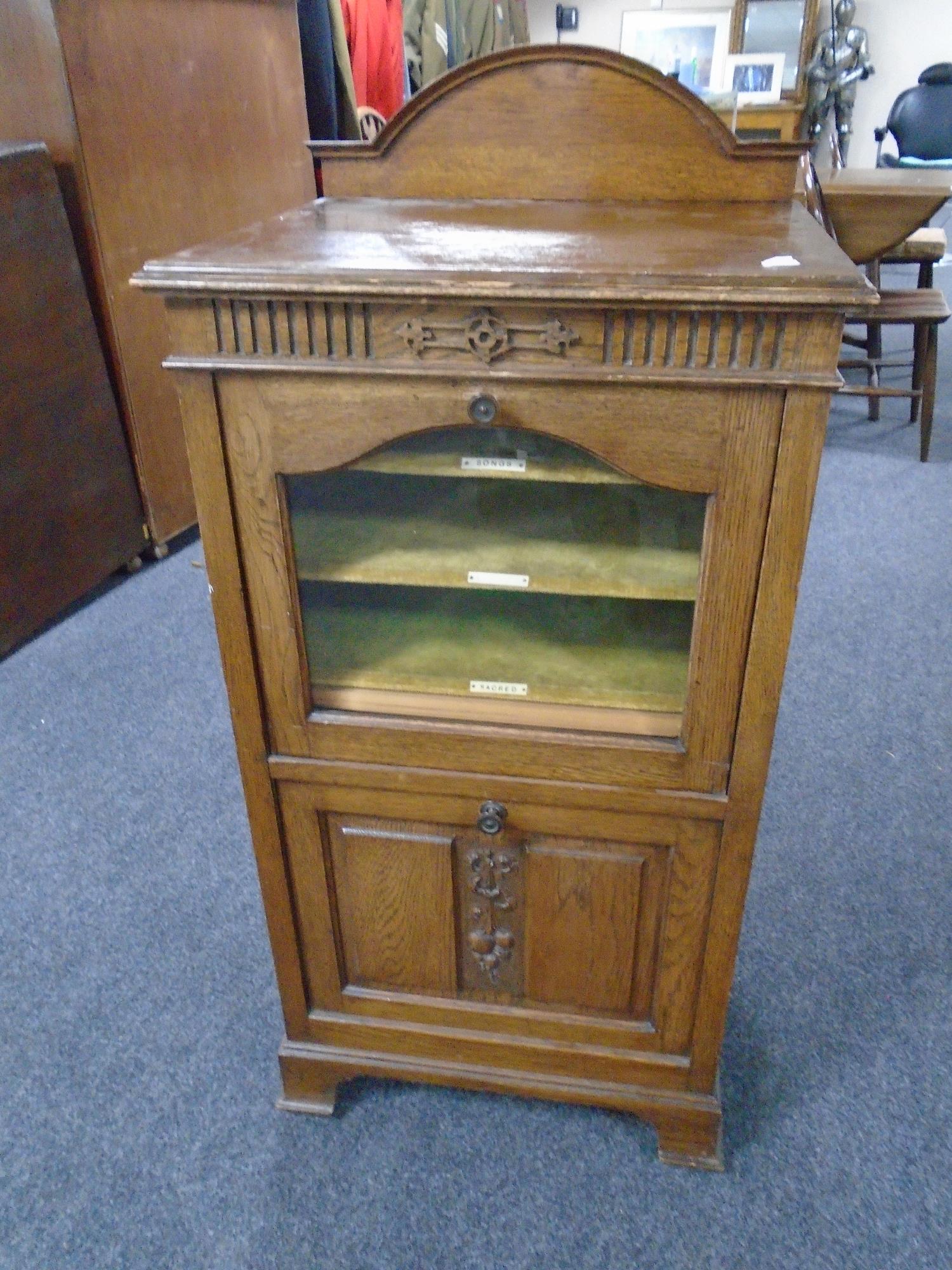 An Edwardian oak music cabinet