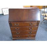 A mahogany bureau fitted with four drawers