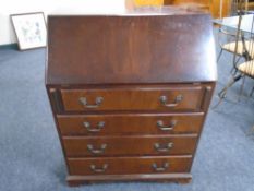 A mahogany bureau fitted with four drawers
