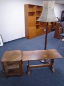 A 20th century three tier book table together with a refectory coffee table and standard lamp with