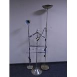 A chrome metal valet stand together with two floor lamps