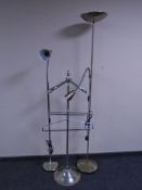 A chrome metal valet stand together with two floor lamps